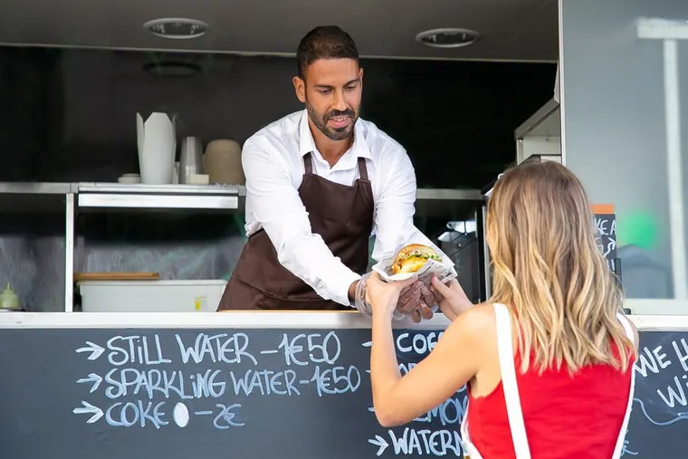 food truck owner checking phone payments