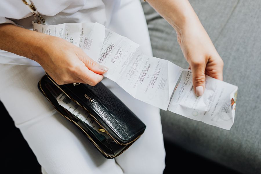 person sorting receipts from wallet